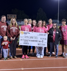 check being presented at pink out event