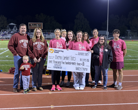 check being presented at pink out event
