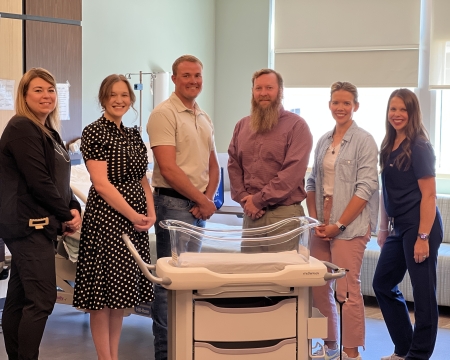 New bassinet with Foundation Board Members and Staff