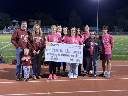 check being presented at pink out event