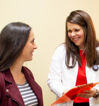 Doctor visiting with woman about women's health.